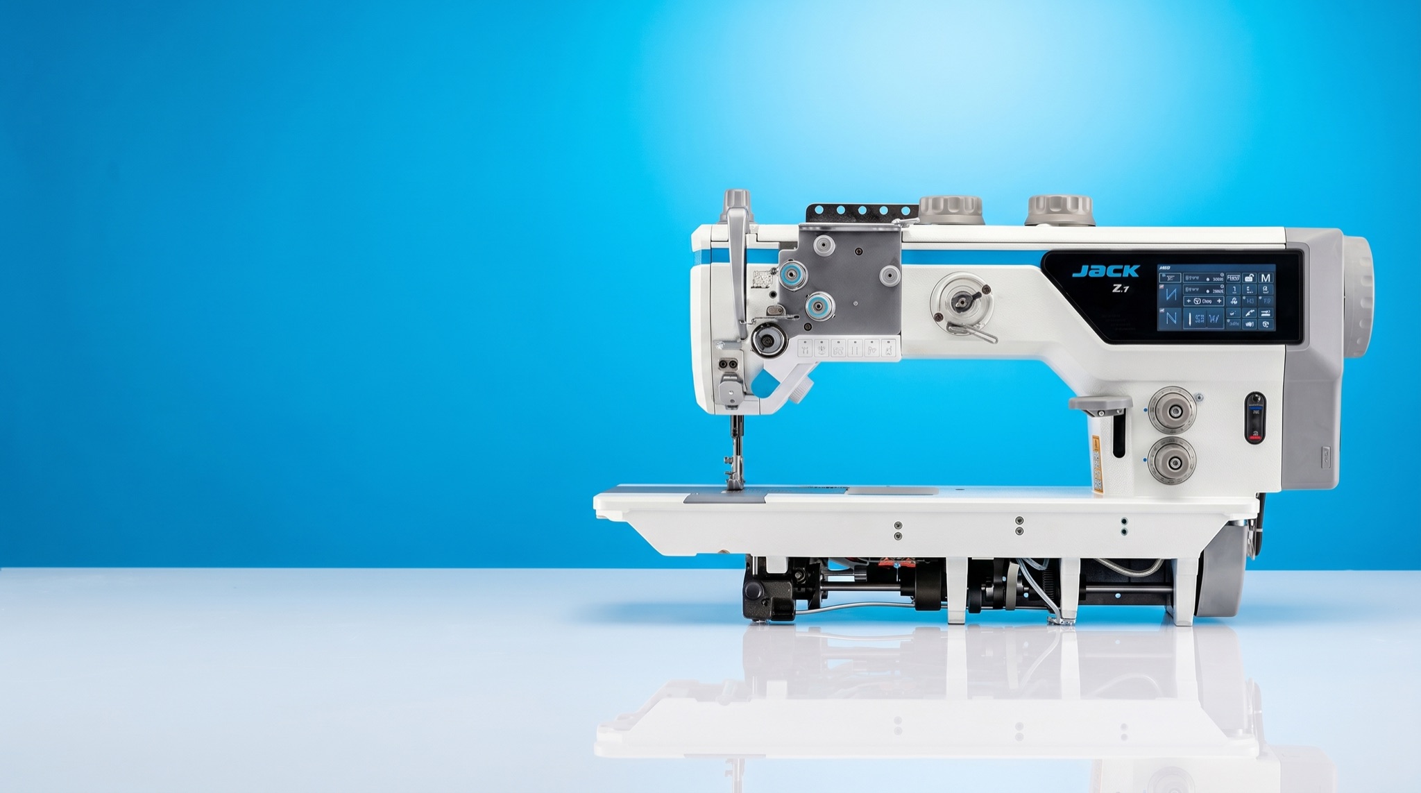 Jack Z7 heavy-duty walking-foot industrial sewing machine on a vivid azure studio panel