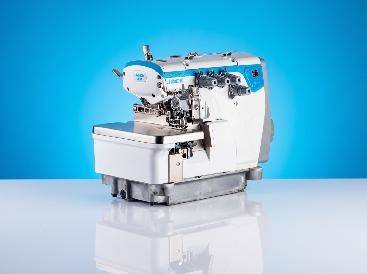Jack multi-thread overlock industrial sewing machine on a vivid azure panel